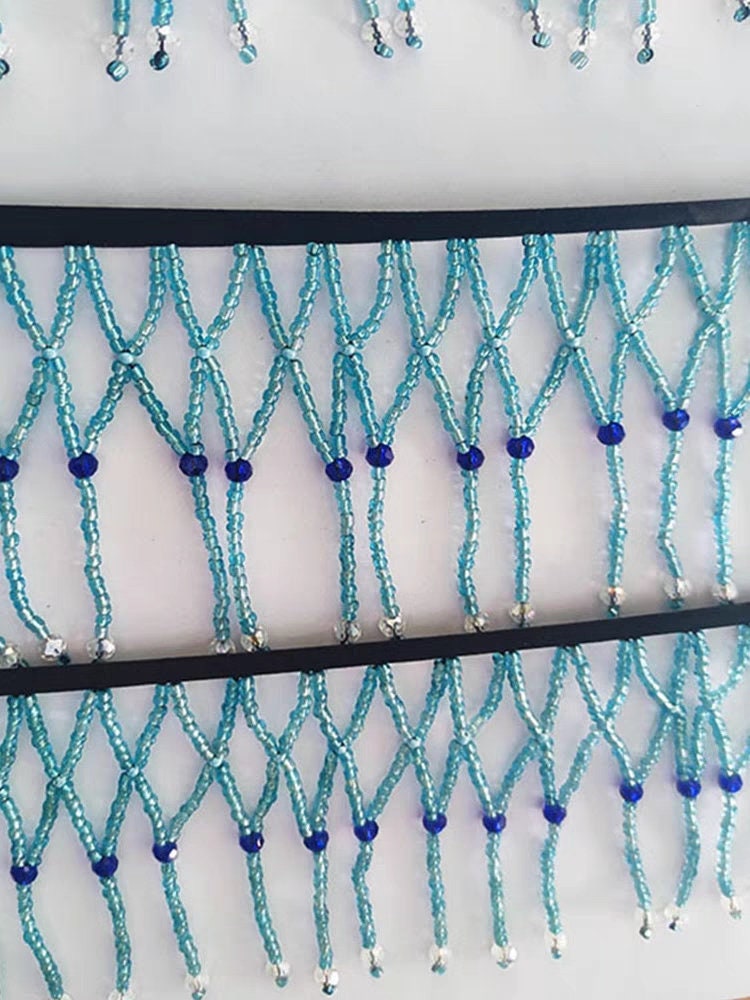 Handgemaakte, 90 cm lange en 10 cm brede, hemelsblauwe gevlochten franje met kralen, geschikt als lampenkapjurk of franje. DIY knutselproject met kralen en franje.